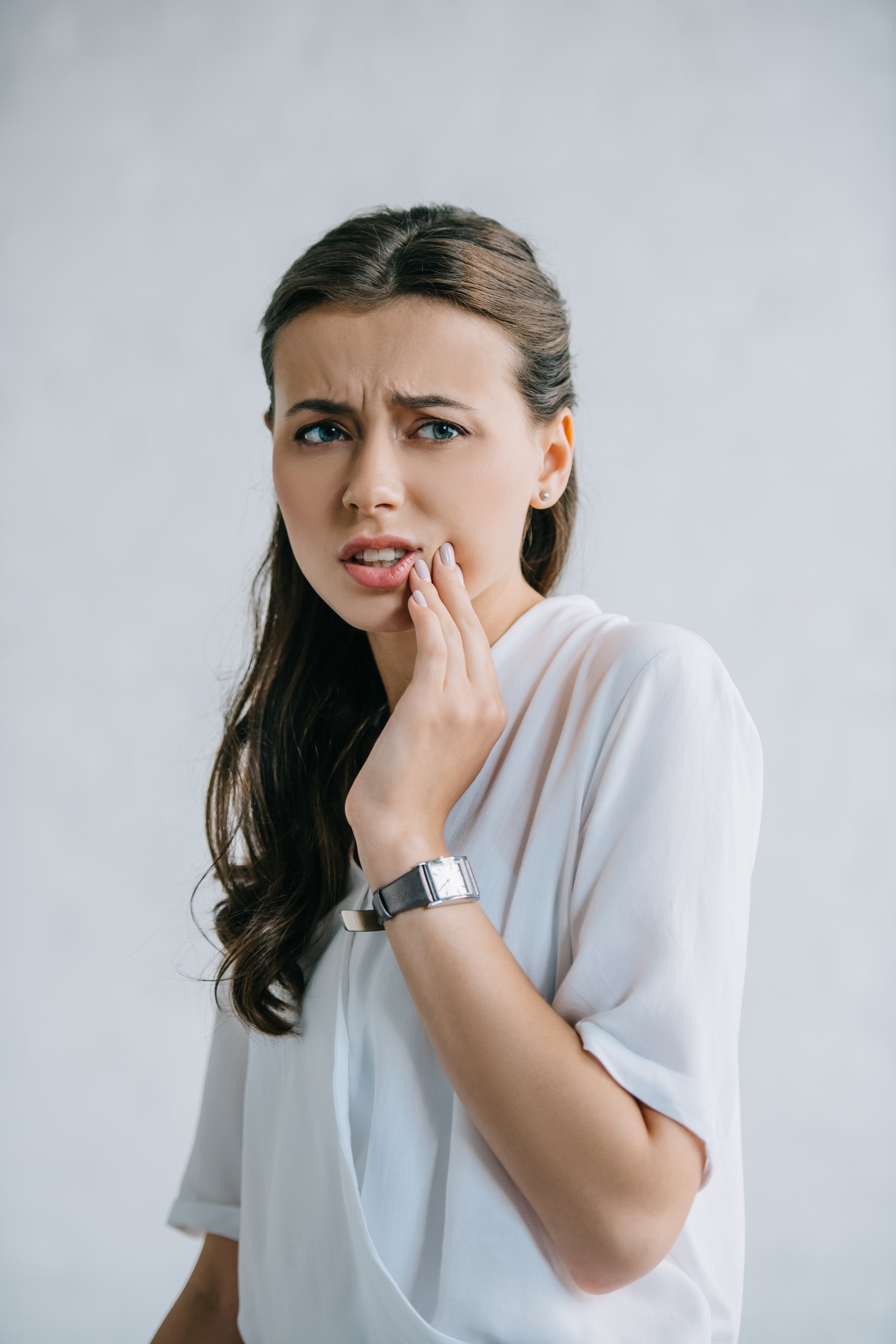 attractive young woman suffering from tooth pain