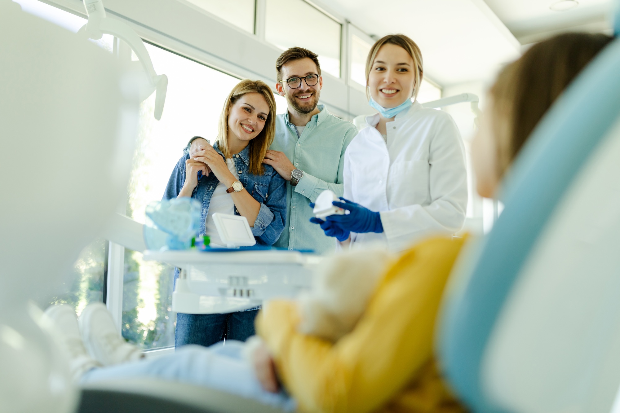 Happy family at visit in the dentist office.